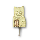 A gold-colored needle threader in the shape of a cat with a magnet in brass and copper recycled ecofriendly metals