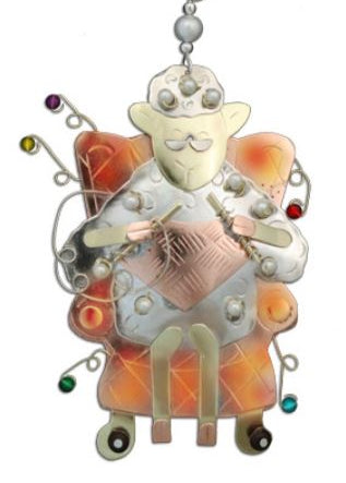 Hand-crafted metal Christmas ornament designed as a knitting sheep with recycled brass, copper, and nickel, adorned with colored beads.