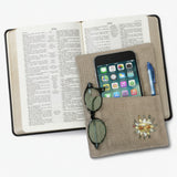 Notebook with phone, sunglasses, and decorative items on a white background